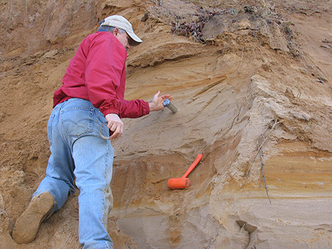Photograph: Milan Pavich (USGS) collects an approximately 50,000-year-old sediment sample for Optically-Stimulated Luminescence dating along the Potomac River (Goose Bay, MD).